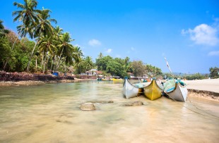 Beautiful view on small indian river with wooden outrigger fishing boats at Baga Beach, Goa, India copy